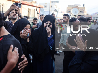 Palestinians mourn their relatives who are killed in overnight Israeli airstrikes on the Al-Bureij refugee camp in central Gaza at the Al-Aq...