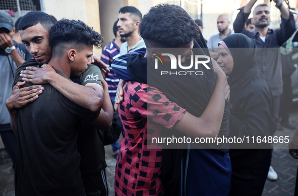 Palestinians mourn their relatives who are killed in overnight Israeli airstrikes on the Al-Bureij refugee camp in central Gaza at the Al-Aq...