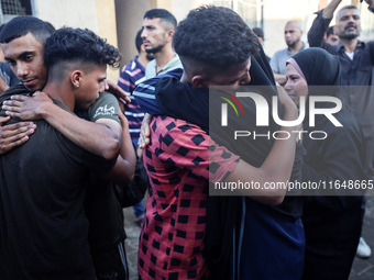 Palestinians mourn their relatives who are killed in overnight Israeli airstrikes on the Al-Bureij refugee camp in central Gaza at the Al-Aq...