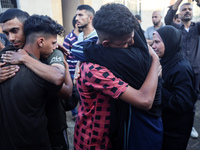 Palestinians mourn their relatives who are killed in overnight Israeli airstrikes on the Al-Bureij refugee camp in central Gaza at the Al-Aq...