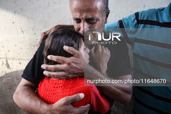 Palestinians mourn their relatives who are killed in overnight Israeli airstrikes on the Al-Bureij refugee camp in central Gaza at the Al-Aq...