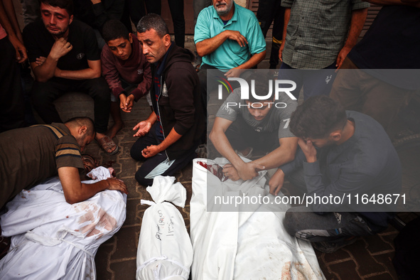 Palestinians mourn their relatives who are killed in overnight Israeli airstrikes on the Al-Bureij refugee camp in central Gaza at the Al-Aq...