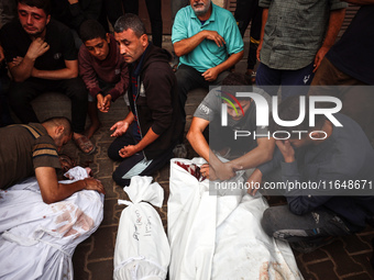 Palestinians mourn their relatives who are killed in overnight Israeli airstrikes on the Al-Bureij refugee camp in central Gaza at the Al-Aq...