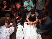 Palestinians mourn their relatives who are killed in overnight Israeli airstrikes on the Al-Bureij refugee camp in central Gaza at the Al-Aq...