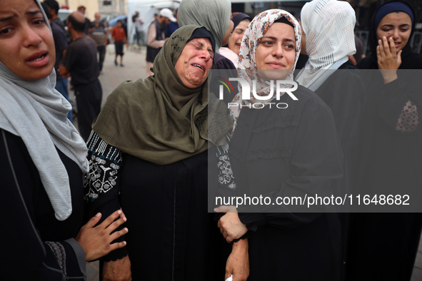 Palestinians mourn their relatives who are killed in overnight Israeli airstrikes on the Al-Bureij refugee camp in central Gaza at the Al-Aq...