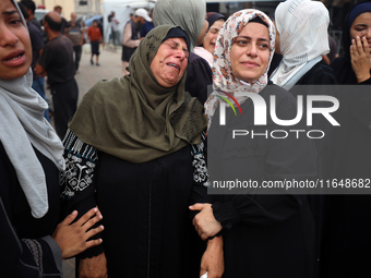 Palestinians mourn their relatives who are killed in overnight Israeli airstrikes on the Al-Bureij refugee camp in central Gaza at the Al-Aq...