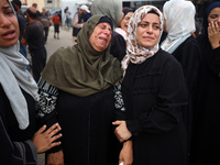 Palestinians mourn their relatives who are killed in overnight Israeli airstrikes on the Al-Bureij refugee camp in central Gaza at the Al-Aq...