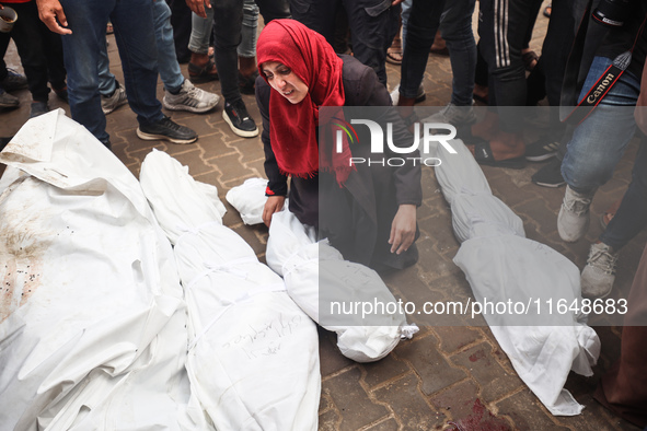 Palestinians mourn their relatives who are killed in overnight Israeli airstrikes on the Al-Bureij refugee camp in central Gaza at the Al-Aq...