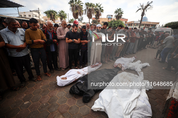 Palestinians mourn their relatives who are killed in overnight Israeli airstrikes on the Al-Bureij refugee camp in central Gaza at the Al-Aq...