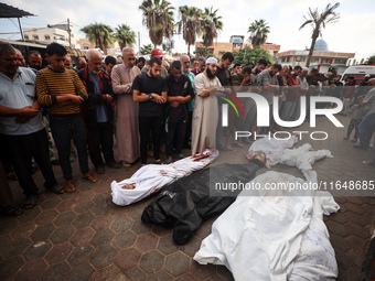 Palestinians mourn their relatives who are killed in overnight Israeli airstrikes on the Al-Bureij refugee camp in central Gaza at the Al-Aq...