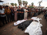 Palestinians mourn their relatives who are killed in overnight Israeli airstrikes on the Al-Bureij refugee camp in central Gaza at the Al-Aq...