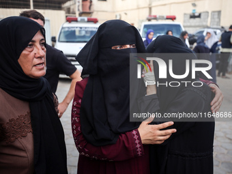 Palestinians mourn their relatives who are killed in overnight Israeli airstrikes on the Al-Bureij refugee camp in central Gaza at the Al-Aq...