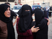 Palestinians mourn their relatives who are killed in overnight Israeli airstrikes on the Al-Bureij refugee camp in central Gaza at the Al-Aq...