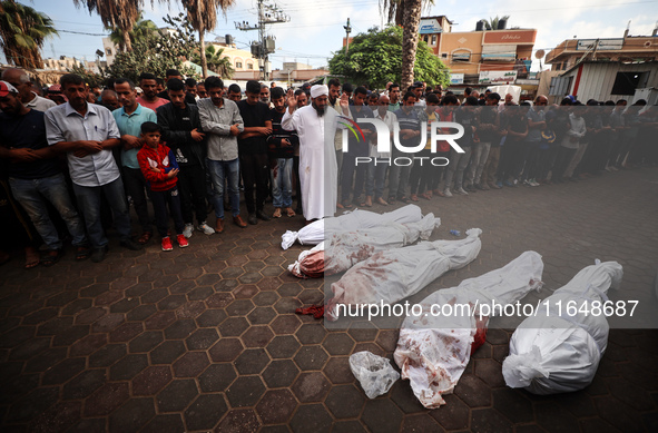 Palestinians mourn their relatives who are killed in overnight Israeli airstrikes on the Al-Bureij refugee camp in central Gaza at the Al-Aq...