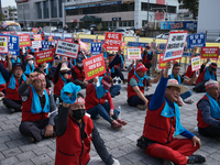 Attendees of a protest organized by around 200 members of the Korea Dog Meat Association and the Korea Dog Meat Sellers' Association hold pl...