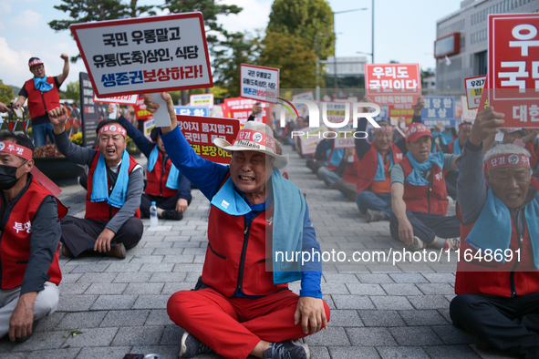 Attendees of a protest organized by around 200 members of the Korea Dog Meat Association and the Korea Dog Meat Sellers' Association hold pl...