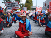 Attendees of a protest organized by around 200 members of the Korea Dog Meat Association and the Korea Dog Meat Sellers' Association hold pl...