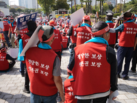 Attendees of a protest organized by around 200 members of the Korea Dog Meat Association and the Korea Dog Meat Sellers' Association hold pl...