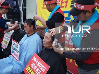 Attendees of a protest organized by the Korea Dog Meat Association and the Korea Dog Meat Sellers' Association shave their heads in front of...