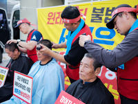 Attendees of a protest organized by the Korea Dog Meat Association and the Korea Dog Meat Sellers' Association shave their heads in front of...