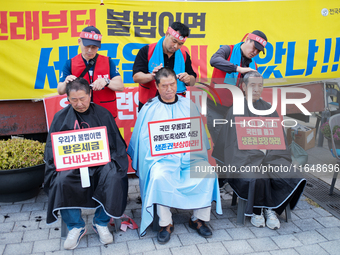 Attendees of a protest organized by the Korea Dog Meat Association and the Korea Dog Meat Sellers' Association shave their heads in front of...