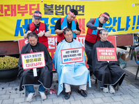 Attendees of a protest organized by the Korea Dog Meat Association and the Korea Dog Meat Sellers' Association shave their heads in front of...