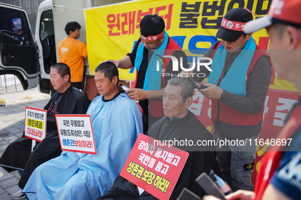 Attendees of a protest organized by the Korea Dog Meat Association and the Korea Dog Meat Sellers' Association shave their heads in front of...