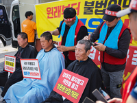 Attendees of a protest organized by the Korea Dog Meat Association and the Korea Dog Meat Sellers' Association shave their heads in front of...