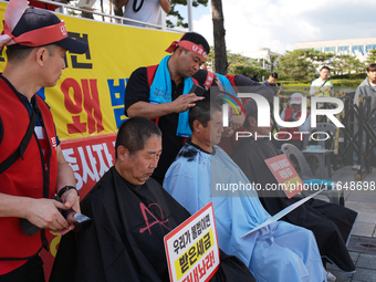 Attendees of a protest organized by the Korea Dog Meat Association and the Korea Dog Meat Sellers' Association shave their heads in front of...