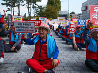 Attendees of a protest organized by around 200 members of the Korea Dog Meat Association and the Korea Dog Meat Sellers' Association hold pl...