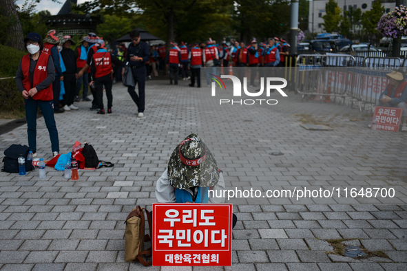 Attendees of a protest organized by around 200 members of the Korea Dog Meat Association and the Korea Dog Meat Sellers' Association hold pl...