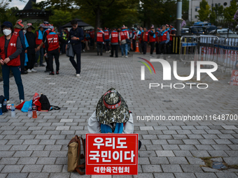 Attendees of a protest organized by around 200 members of the Korea Dog Meat Association and the Korea Dog Meat Sellers' Association hold pl...