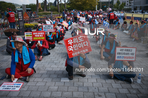 Attendees of a protest organized by around 200 members of the Korea Dog Meat Association and the Korea Dog Meat Sellers' Association hold pl...