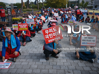 Attendees of a protest organized by around 200 members of the Korea Dog Meat Association and the Korea Dog Meat Sellers' Association hold pl...