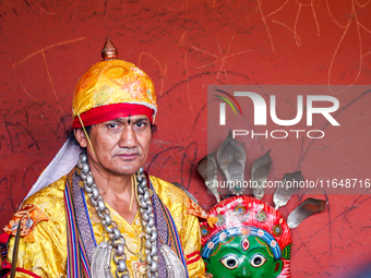 A Nepalese Hindu devotee impersonates a deity, wearing traditional deity clothes and ornaments for the celebration of the Shikali Jatra Fest...