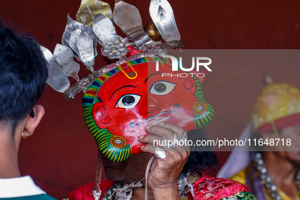 A Nepalese Hindu devotee impersonates a deity, wearing traditional deity clothes and ornaments for the celebration of the Shikali Jatra Fest...