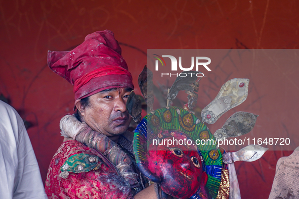 A Nepalese Hindu devotee impersonates a deity, wearing traditional deity clothes and ornaments for the celebration of the Shikali Jatra Fest...