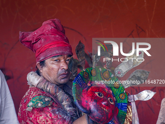 A Nepalese Hindu devotee impersonates a deity, wearing traditional deity clothes and ornaments for the celebration of the Shikali Jatra Fest...