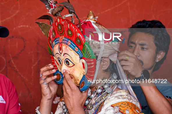 A Nepalese Hindu devotee impersonates a deity, wearing traditional deity clothes and ornaments for the celebration of the Shikali Jatra Fest...