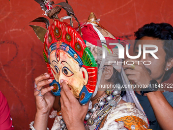 A Nepalese Hindu devotee impersonates a deity, wearing traditional deity clothes and ornaments for the celebration of the Shikali Jatra Fest...