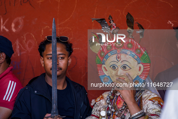 A Nepalese Hindu devotee impersonates a deity, wearing traditional deity clothes and ornaments for the celebration of the Shikali Jatra Fest...