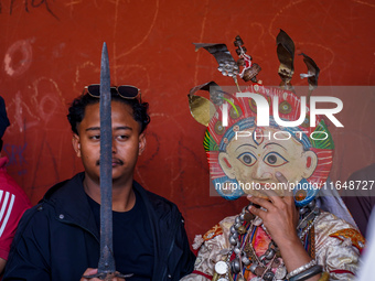 A Nepalese Hindu devotee impersonates a deity, wearing traditional deity clothes and ornaments for the celebration of the Shikali Jatra Fest...