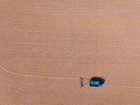 A farmer dries corn in Liaocheng, China, on October 8, 2024. (