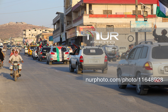 Palestinians in northern Syria commemorate October 7, 2024, by waving Palestinian flags and driving through the streets in their cars. 