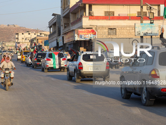 Palestinians in northern Syria commemorate October 7, 2024, by waving Palestinian flags and driving through the streets in their cars. (