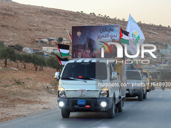 Palestinians in northern Syria commemorate October 7, 2024, by waving Palestinian flags and driving through the streets in their cars. (