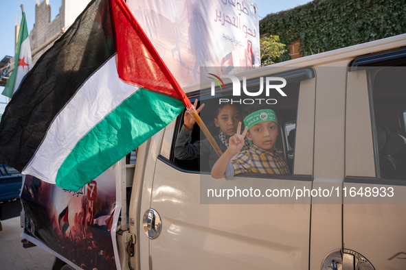 Palestinians in northern Syria commemorate October 7, 2024, by waving Palestinian flags and driving through the streets in their cars. 