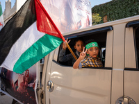 Palestinians in northern Syria commemorate October 7, 2024, by waving Palestinian flags and driving through the streets in their cars. (