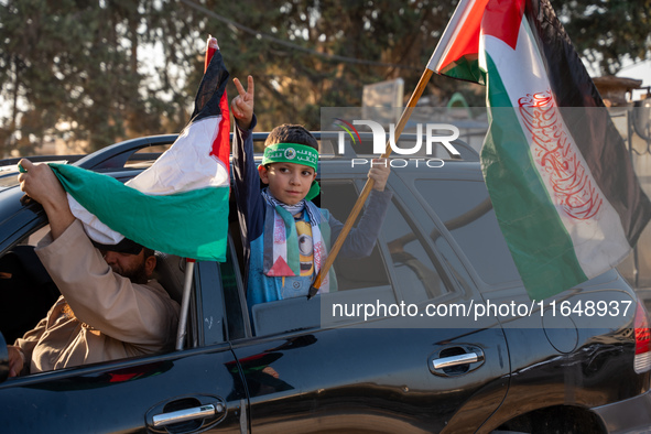 Palestinians in northern Syria commemorate October 7, 2024, by waving Palestinian flags and driving through the streets in their cars. 