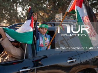 Palestinians in northern Syria commemorate October 7, 2024, by waving Palestinian flags and driving through the streets in their cars. (